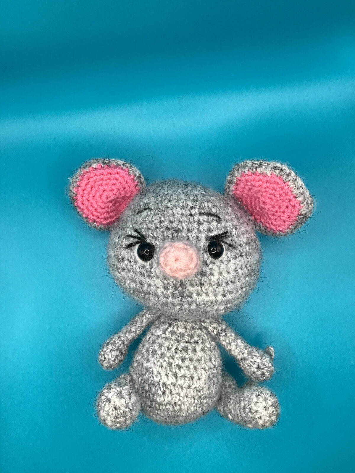 Gray crocheted mouse with pink ears and nose