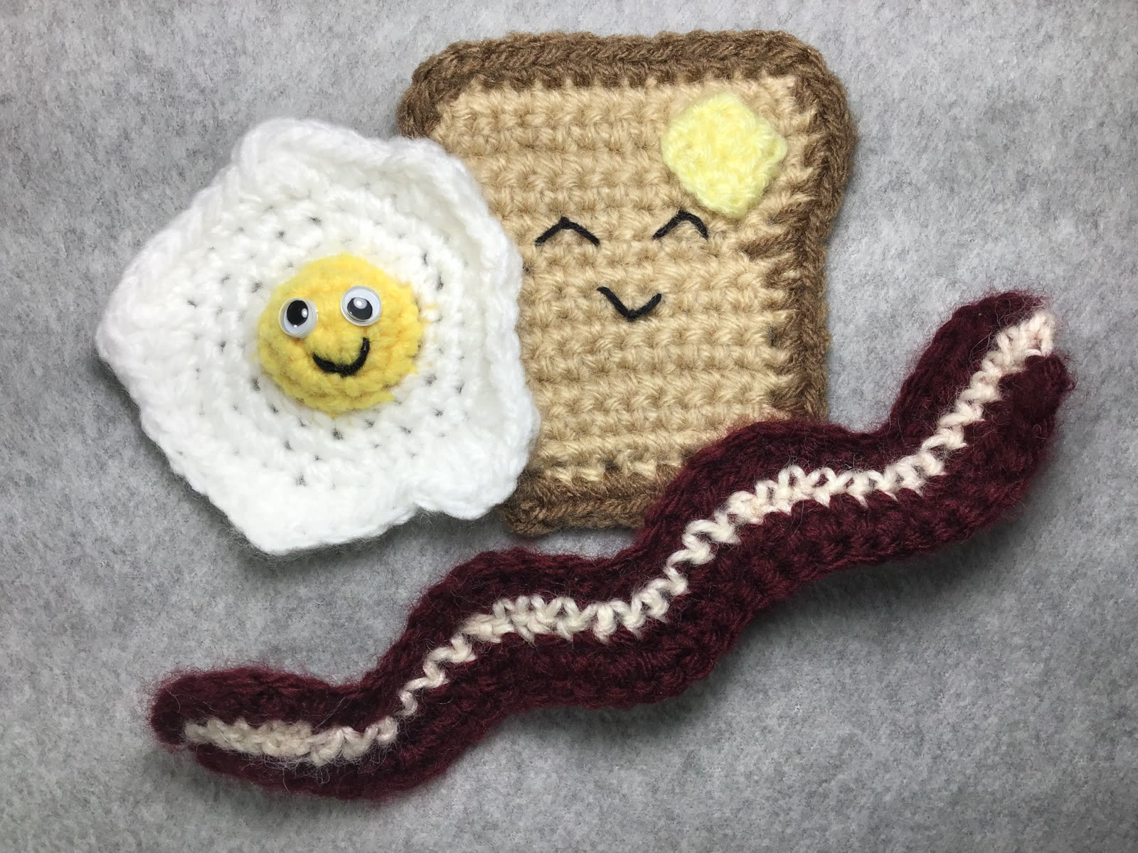 Smiling crocheted egg, toast, and bacon